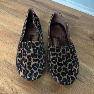 Born slip on animal print shoes.